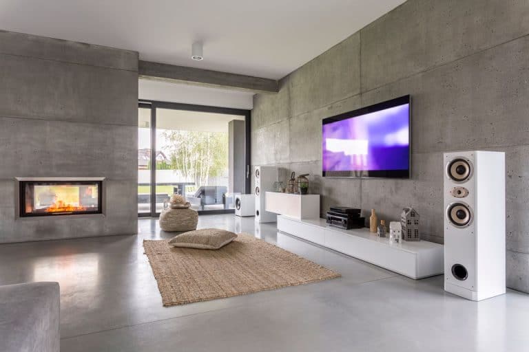 TV living room with large speakers window fireplace and concrete walls, 27 Living Rooms With A Fireplace And TV