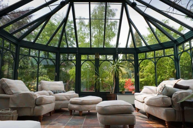 Very ambient living entertainment room with glass walls and glass roofing