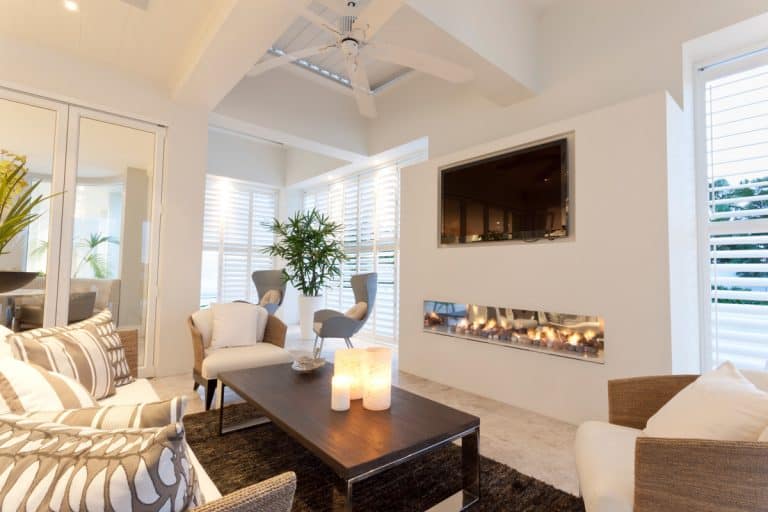A small living room with a nice furniture placement and a small fire place as the centerpiece, 11 Sofa and Two Chairs Living Room Layouts
