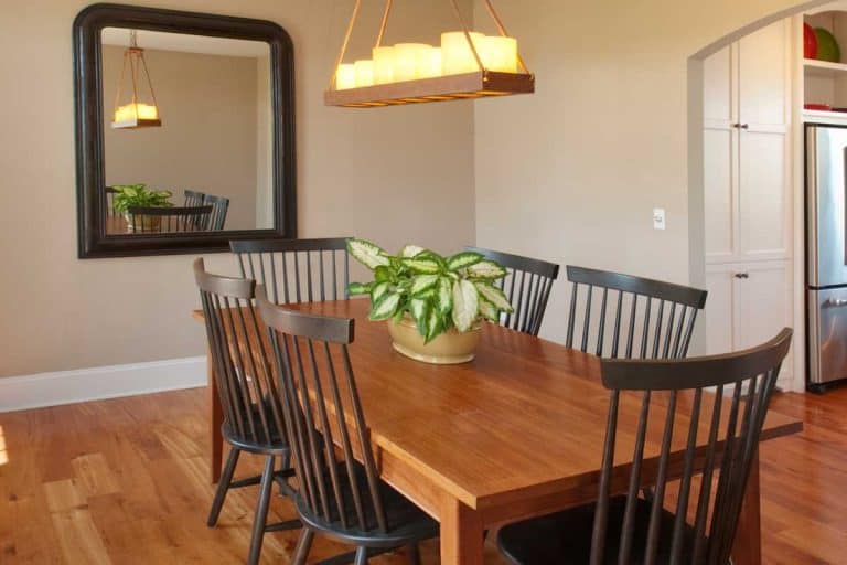 Beautiful simple country style dining room, hardwood floor and candle chandelier, Should You Put A Mirror In The Dining Room? [Here's How]