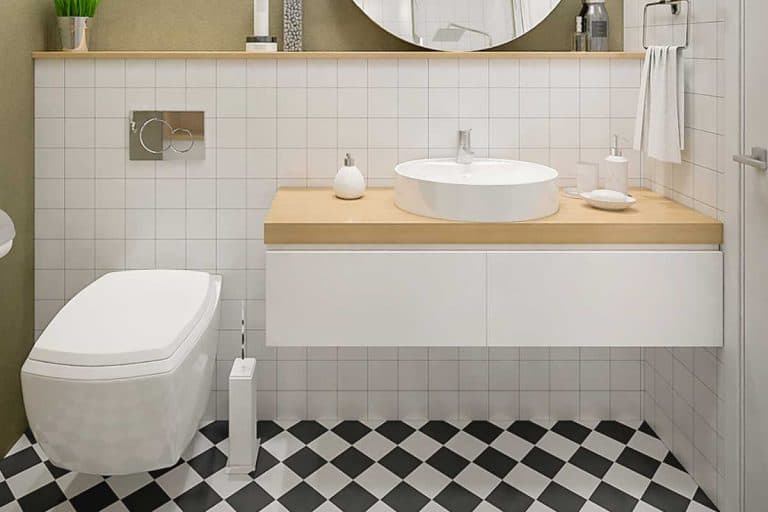 Cozy modern bathroom with black and white floor and tiled walls, Should You Tile Behind Bathroom Sink? [Inc. What Kind Of Backsplash To Have]