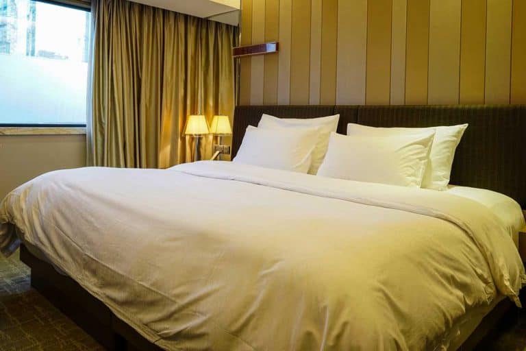 Elegant and comfortable bedroom interior with white pillows, What Size Pillows Go On A King Bed [And How Many Do You Need]?