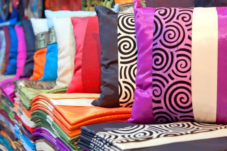 Silk and satin pillowcases and cushions displayed on pillow shop, Which Is Better- Silk or Satin Pillowcases?