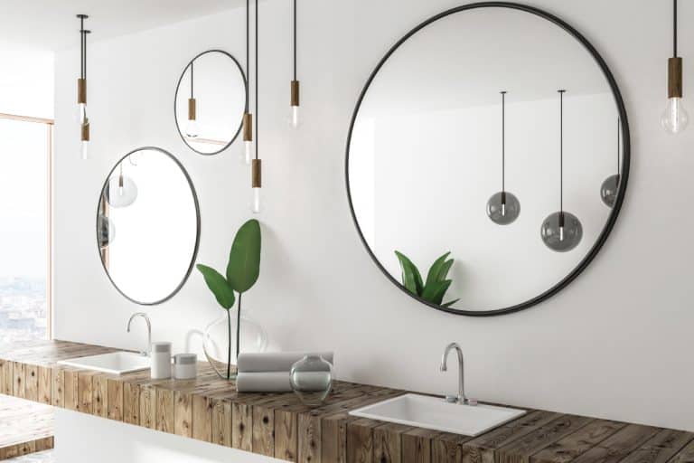 Double sink with wooden countertop in white bathroom interior, How Far Should Bathroom Mirror Be Above Sink?