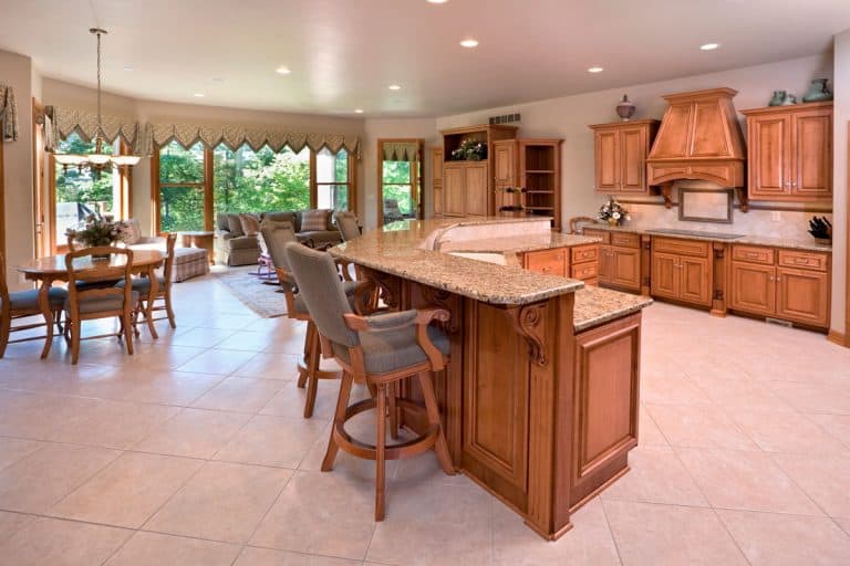 Rustic themed kitchen with maple cabinetry and wooden laminated flooring, What Color Countertops Goes With Maple Cabinets