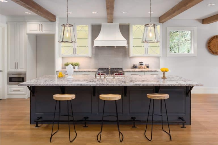 kitchen in new luxury home with island, pendant lights, and glass fronted cabinets, What Color Countertops Go With White Cabinets