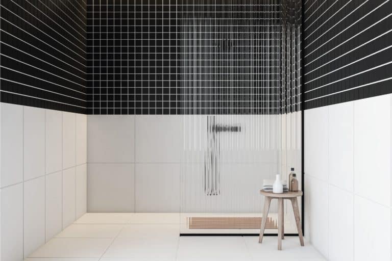 Black and white tiled shower in bathroom with shower bench, How Much Does A Shower Bench Cost?