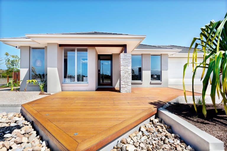 Wooden yard with big rocks around a modern mansion, What Color Deck Goes With A Grey House?