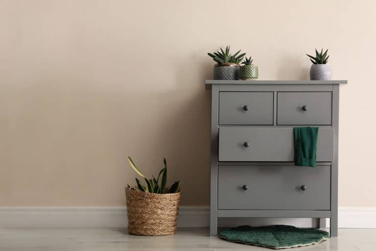 Room interior with grey chest of drawers near beige wall, Can You Paint Ikea Malm Dresser? [And How To]