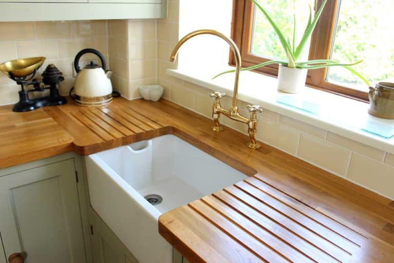 Traditional country kitchen with wooden countertops and white ceramic sink, Does Ikea Cut Countertops?