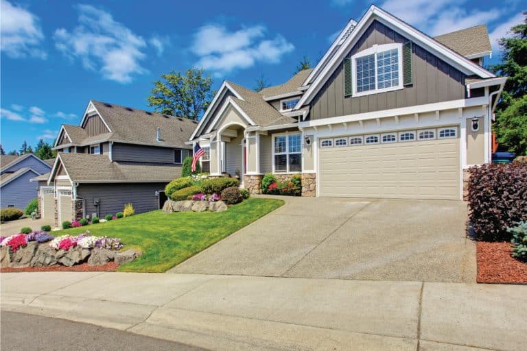 house with beautiful landscape and vivid flowers, steep driveway. How Steep Can A Driveway Be