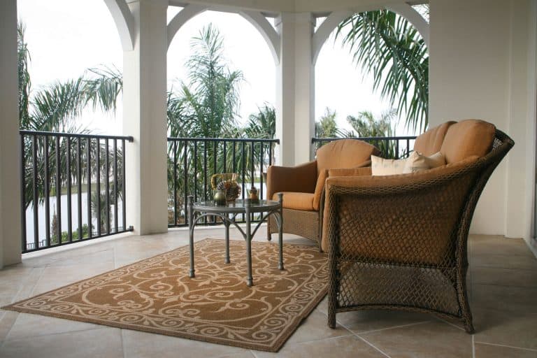 A porch with pattern rug, coffee table and a chair, How Big Should A Porch Rug Be?