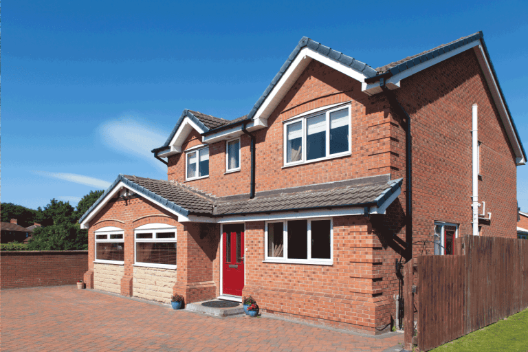 English detached red brick house with red door. What Color Pavers Go With Red Brick House