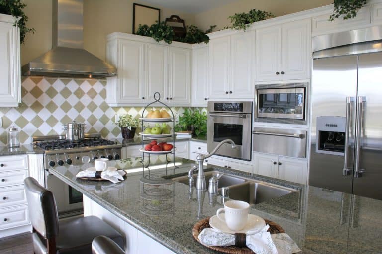 Picture of a modern kitchen with white cabinets and stainless appliances, What Color Cabinets Go With Gray Countertops?