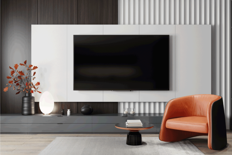modern black and white living room, small indoor plant, upholstered single seat. 15 Captivating Wall Decor Ideas For Above And Around TV