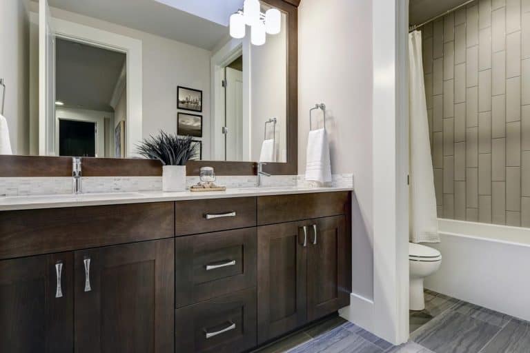 Double vanity cabinet topped with white counter, How To Fill The Gap Between Vanity Top And Wall
