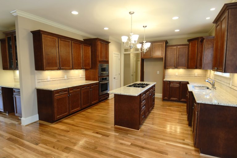 Ultra rustic classic kitchen with dark oak cabinets and cupboards matched with white marble countertop, How High Should Kitchen Counters Be?