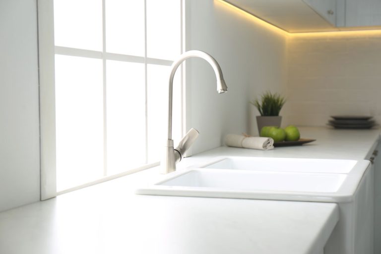 New ceramic sink and modern tap in stylish kitchen interior, 7 Best Sink Repair Kits [Porcelain And Ceramic]