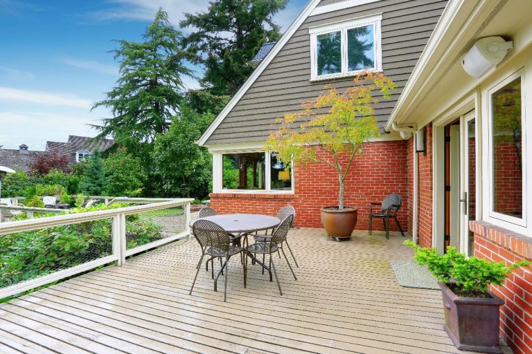 A walkout deck of a red brick house, What Color Deck Goes With A Red Brick House?