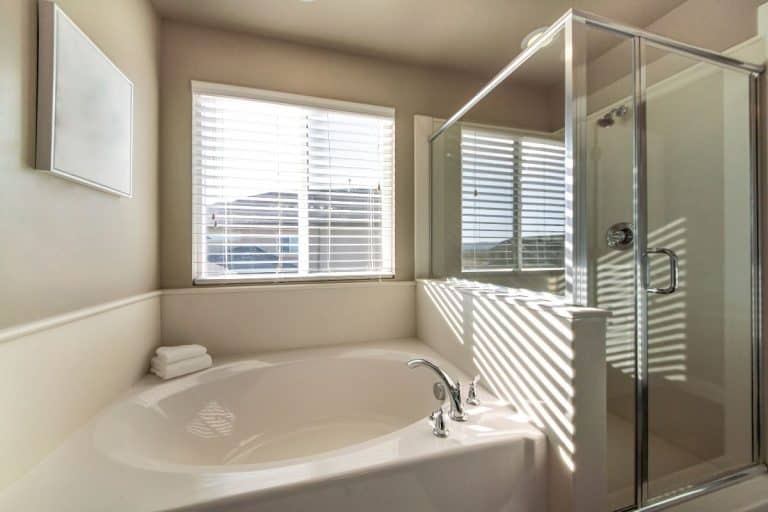 Bathtub and shower stall in a bathroom with window, How To Install A Moen Widespread Bathroom Faucet [Step By Step Guide]