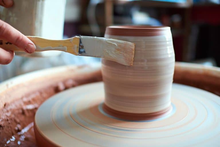 potter at work. production process of pottery. Application of glaze brush on ceramic ware, What Spray Paint Will Stick To Glazed Ceramic [Do You Need To Prime Before]