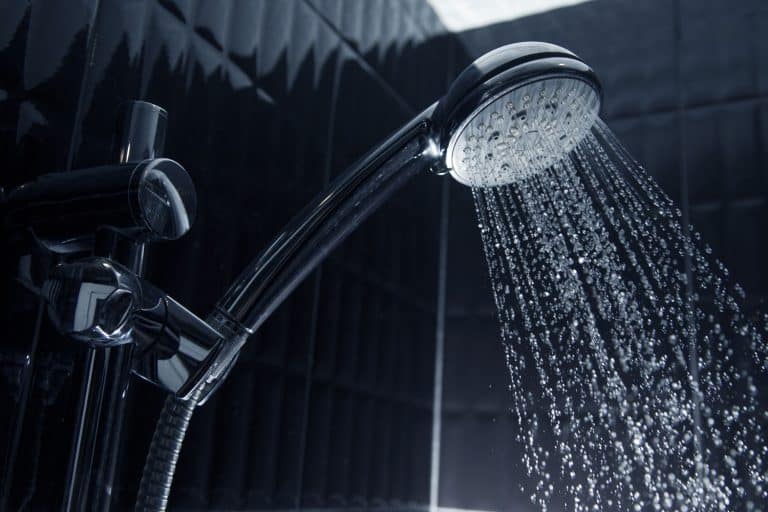Close up of Water flowing from shower in the bathroom, How To Reset A Moen Shower [Step By Step Guide]