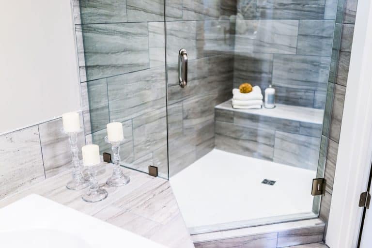 Up close photo of a modern glass shower door with a stianless steel door handle, Up close photo of a modern glass shower door with a stianless steel door handle, My Shower Door Is Not Latching - Why? What To Do?