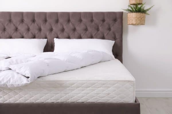 Comfortable bed with new mattress in room. Healthy sleep - How Long and Wide is a Box Spring? [Including Twin, Queen, and King]